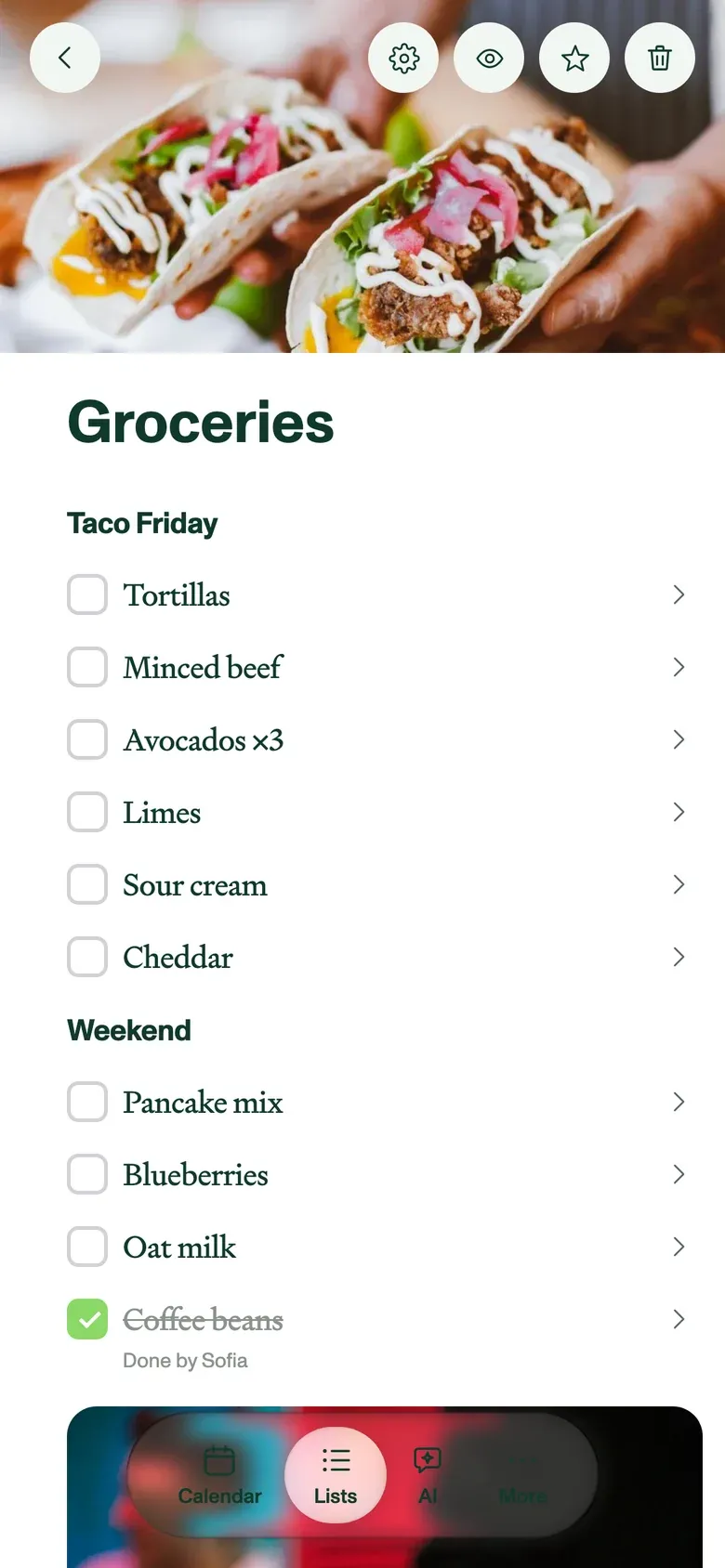 The grocery list on a phone, in headed sections with a photo at the top.